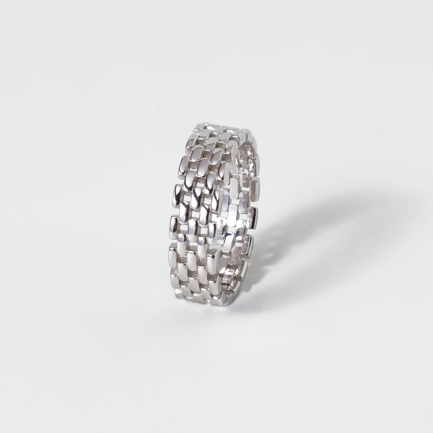 Silver textured ring on a white background