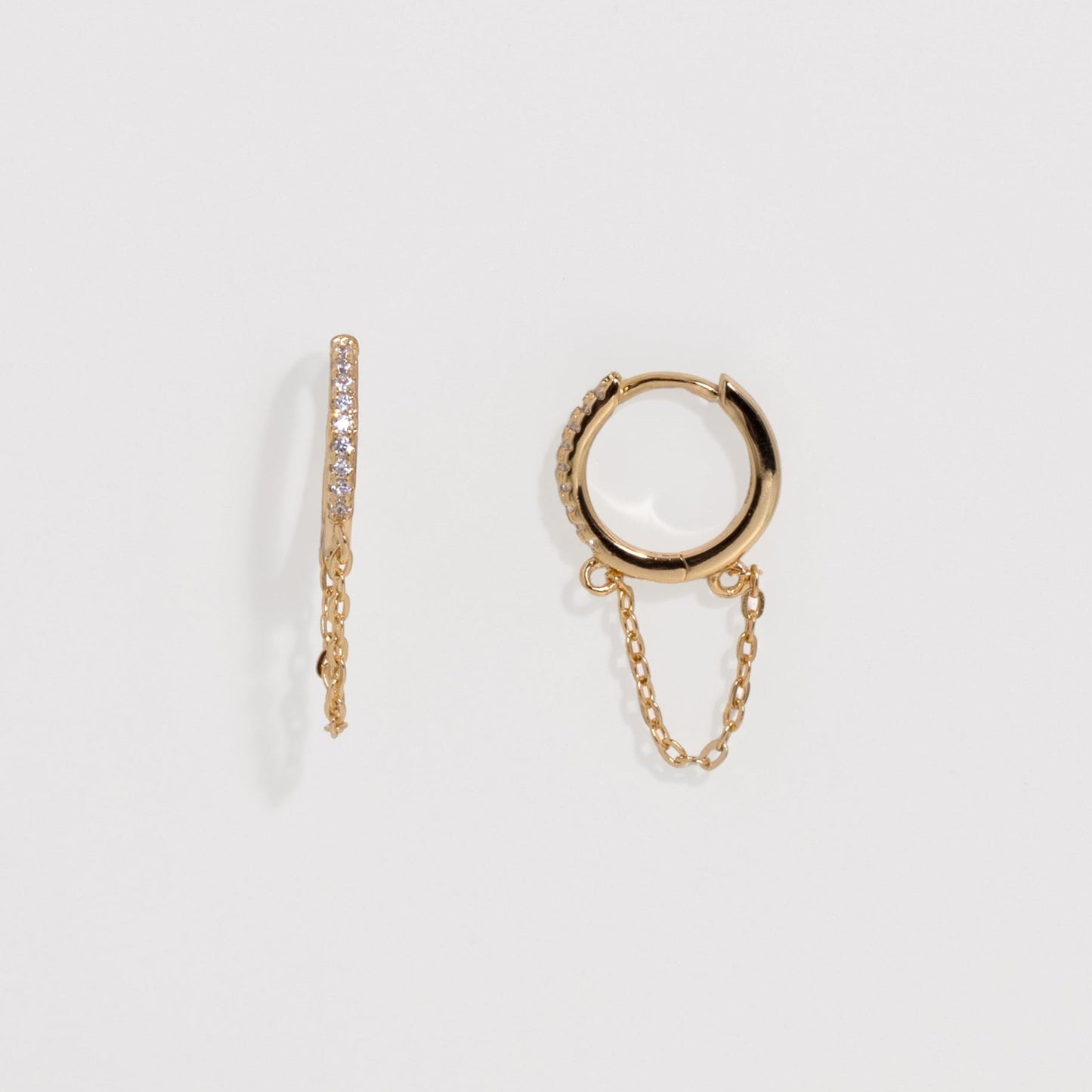 Gold hoop earrings with chain detail on a light gray background