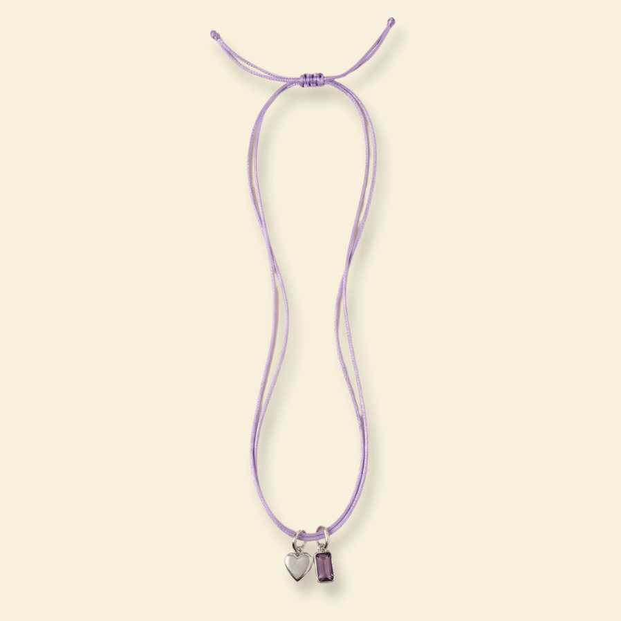 Necklace with heart-shaped charms on a light beige background