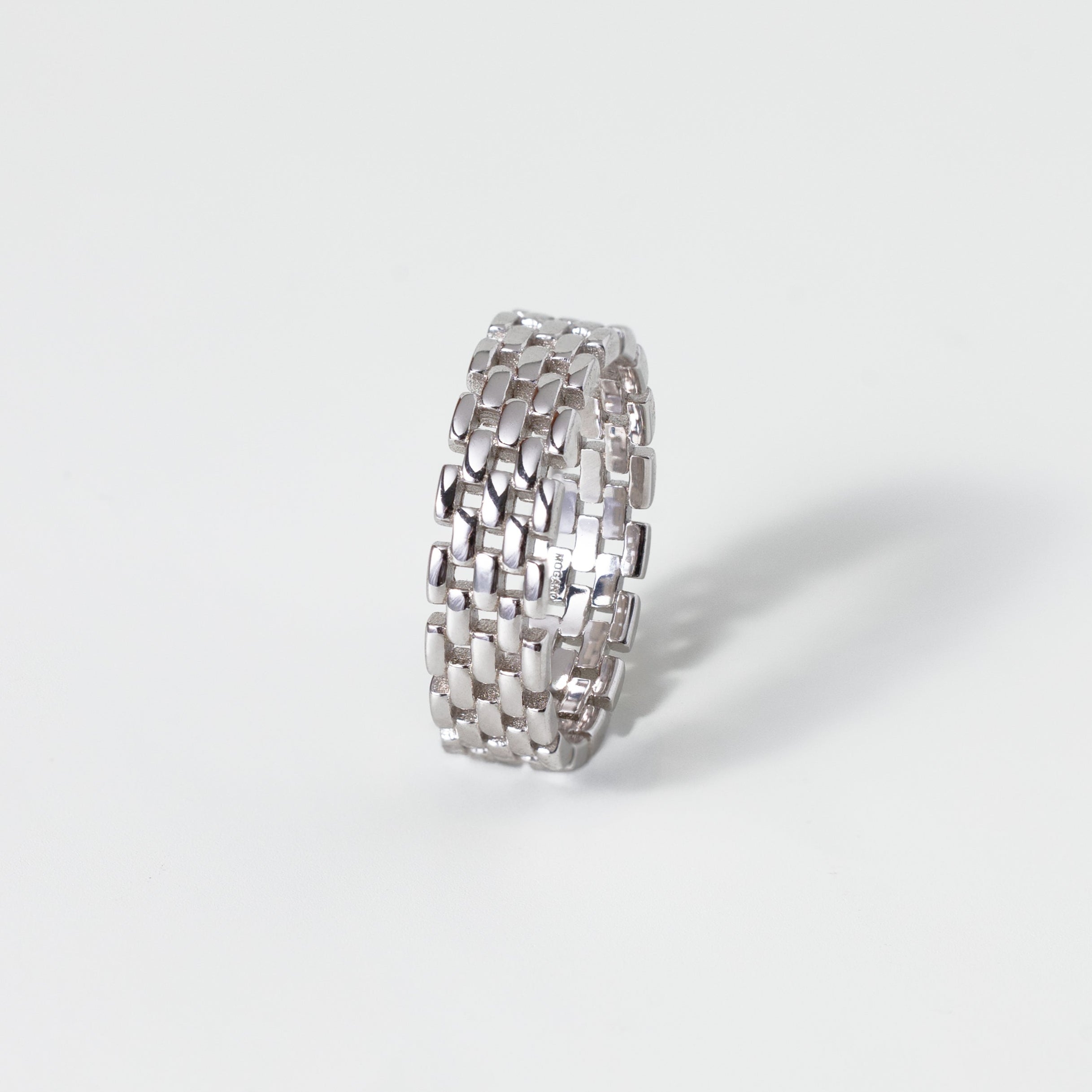 Silver textured ring on a white background