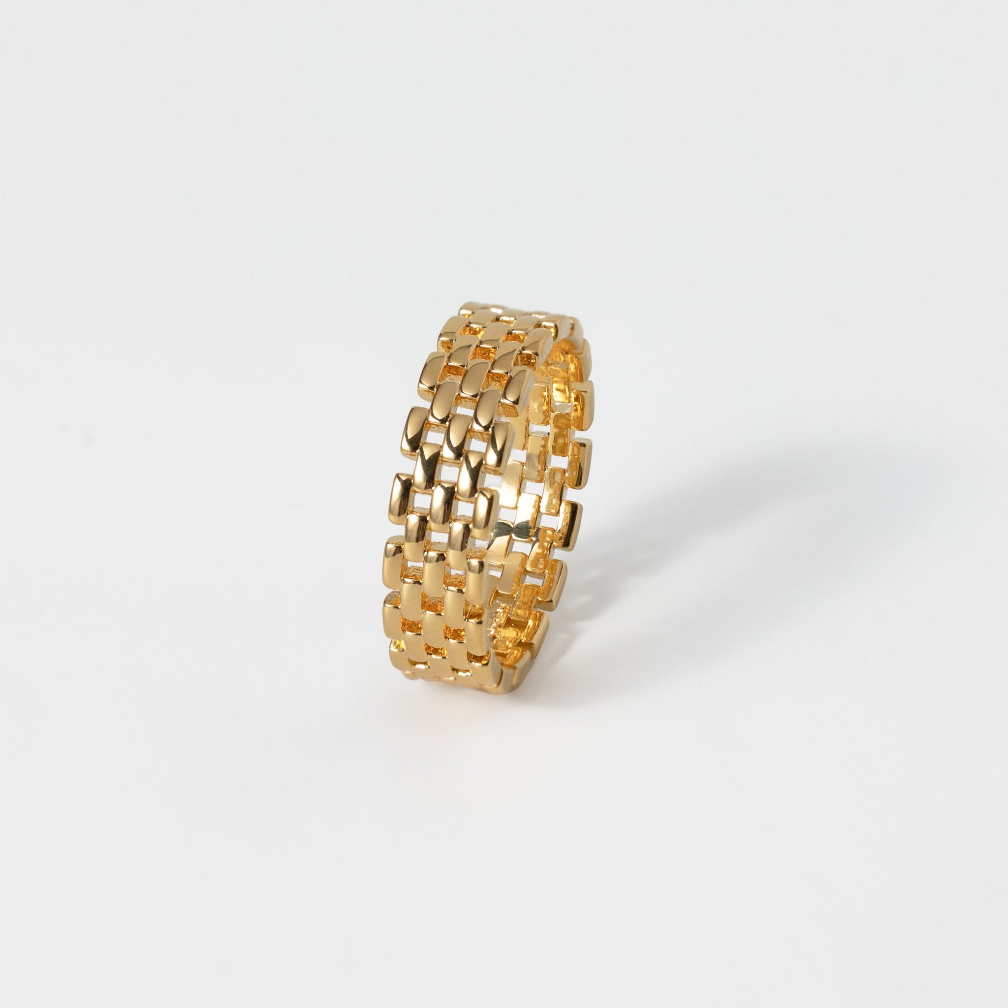 Gold textured ring on a white background