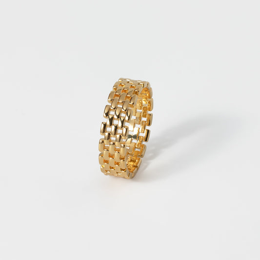 Gold textured ring on a white background