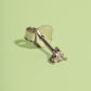 Silver ring with a diamond on a light green background